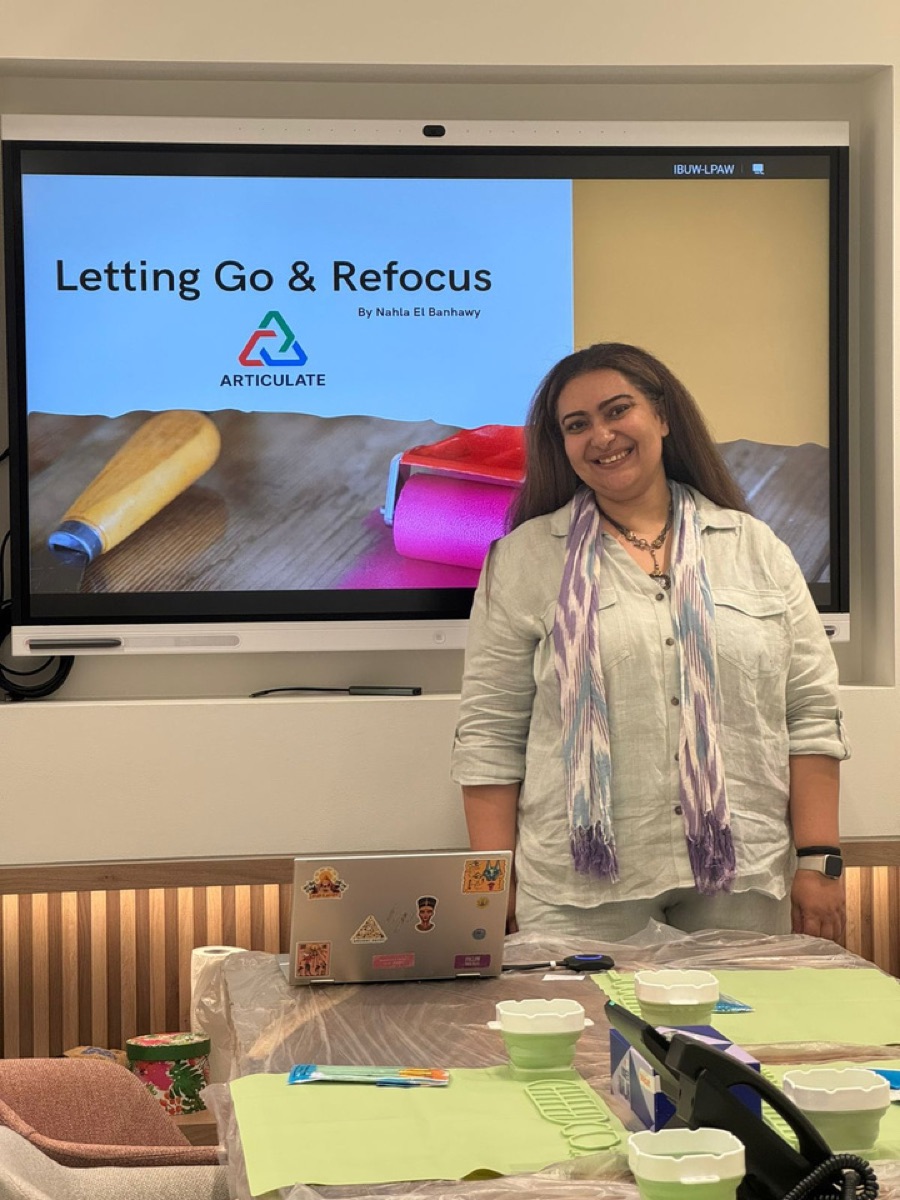 Nahla ElBanhawy facilitating the Letting Go & Refocus workshop, materials laid out on the table